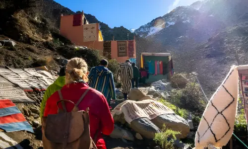 Travelers hiking through a Berber village in the Atlas Mountains, Morocco