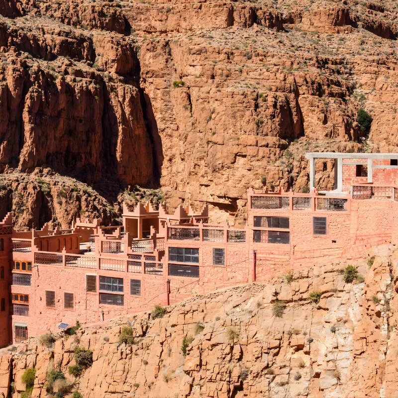 Kasbah-style hotel set against the red cliffs of Dades Valley on the 4-Day Marrakech to Merzouga Desert Tour