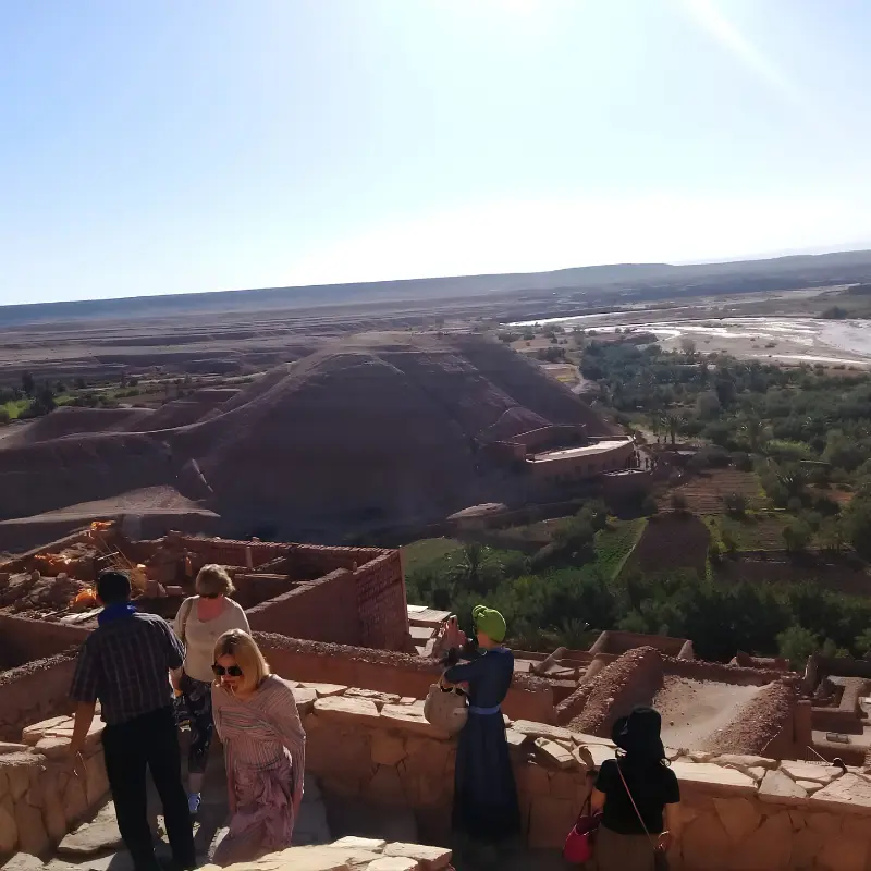 Travelers enjoying the panoramic view over Ait Ben Haddou during a private 4-Day Marrakech to Merzouga Desert Tour