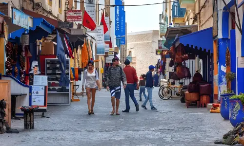 Tourists walking through the colorful medina of Essaouira, Morocco